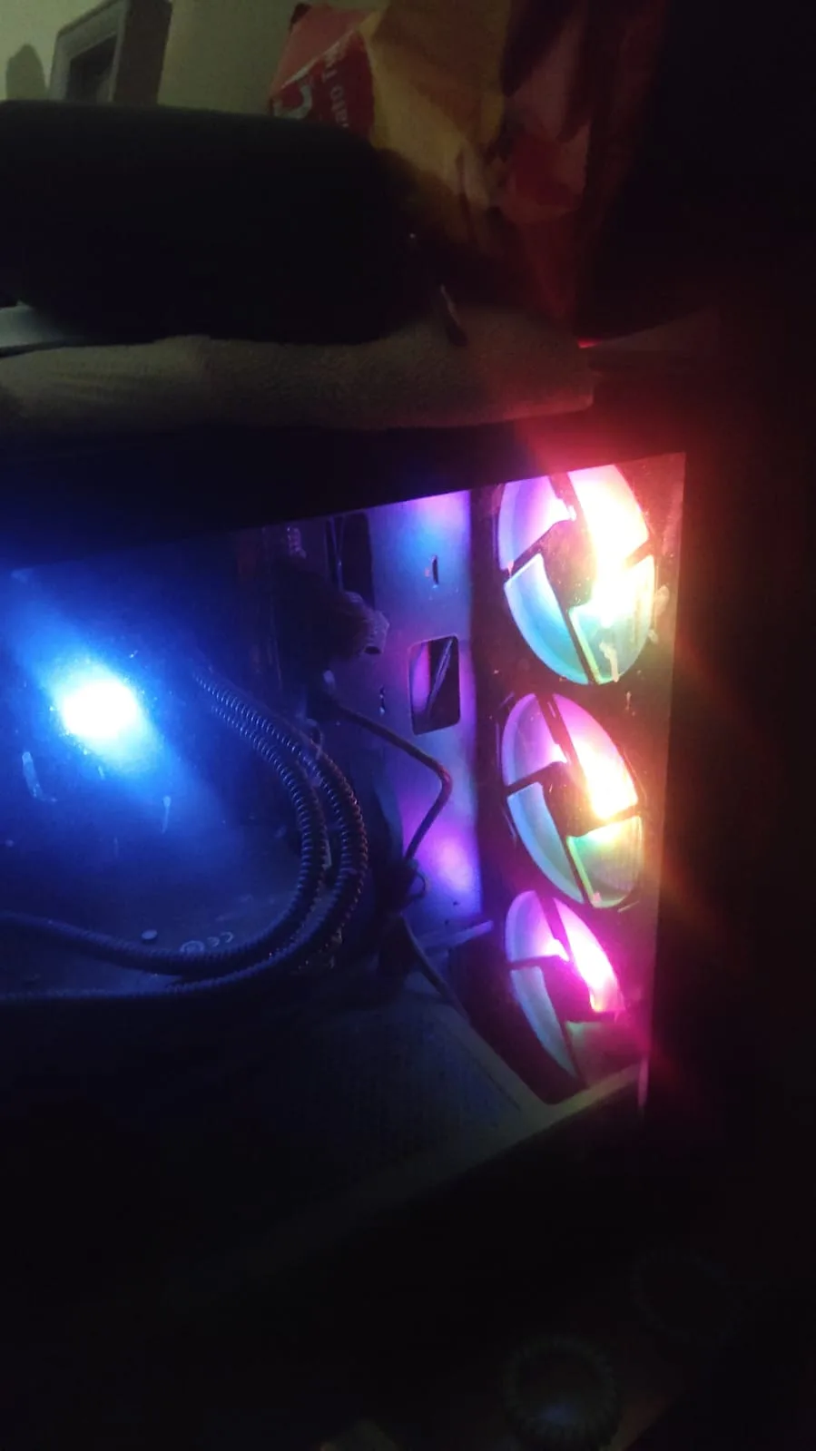 The home server, an RGB PC tower glowing with three lit fans and a blue-lit AIO cooler inside.