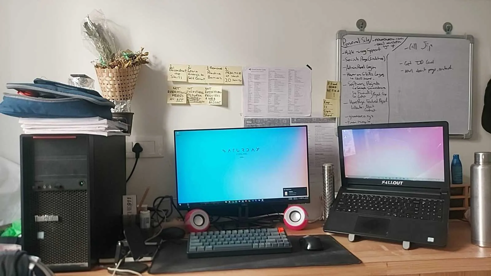 The dual-machine era: a ThinkStation tower and monitor next to the Dell laptop, with a whiteboard full of plans and sticky notes on the wall.